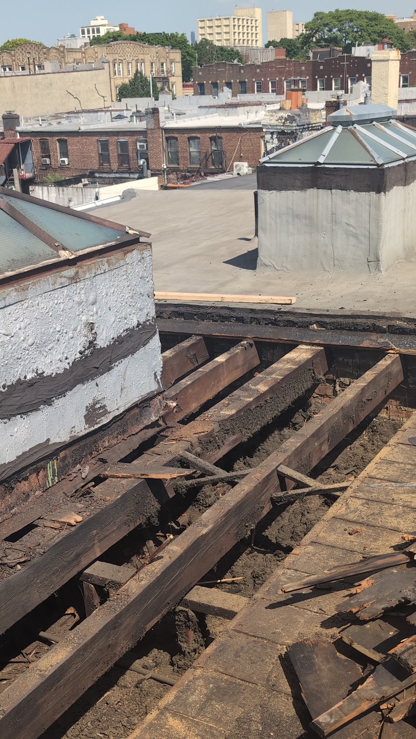 Opened Brooklyn roof showing concealed deck and framing deterioration