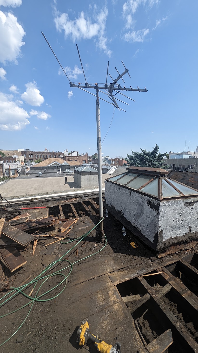 Wide roof-level view of opened decking around rooftop structures