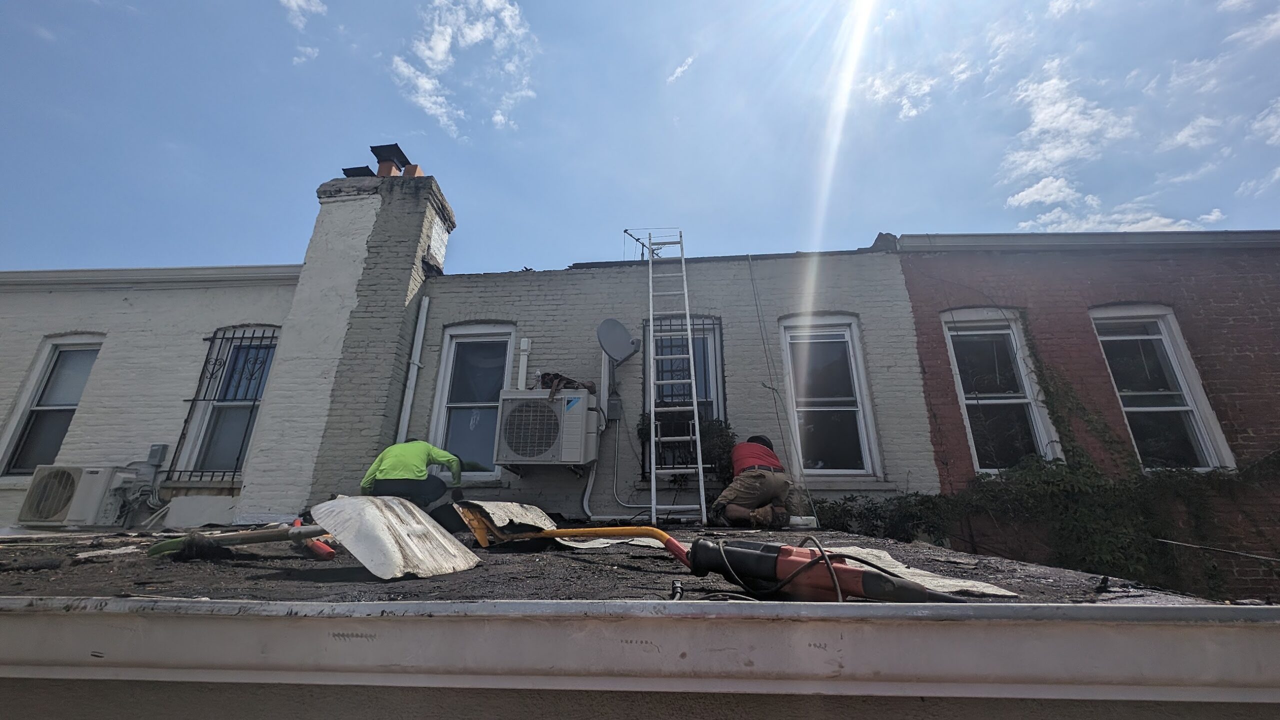 Kellets roof crew performing controlled tear-off at a roof edge