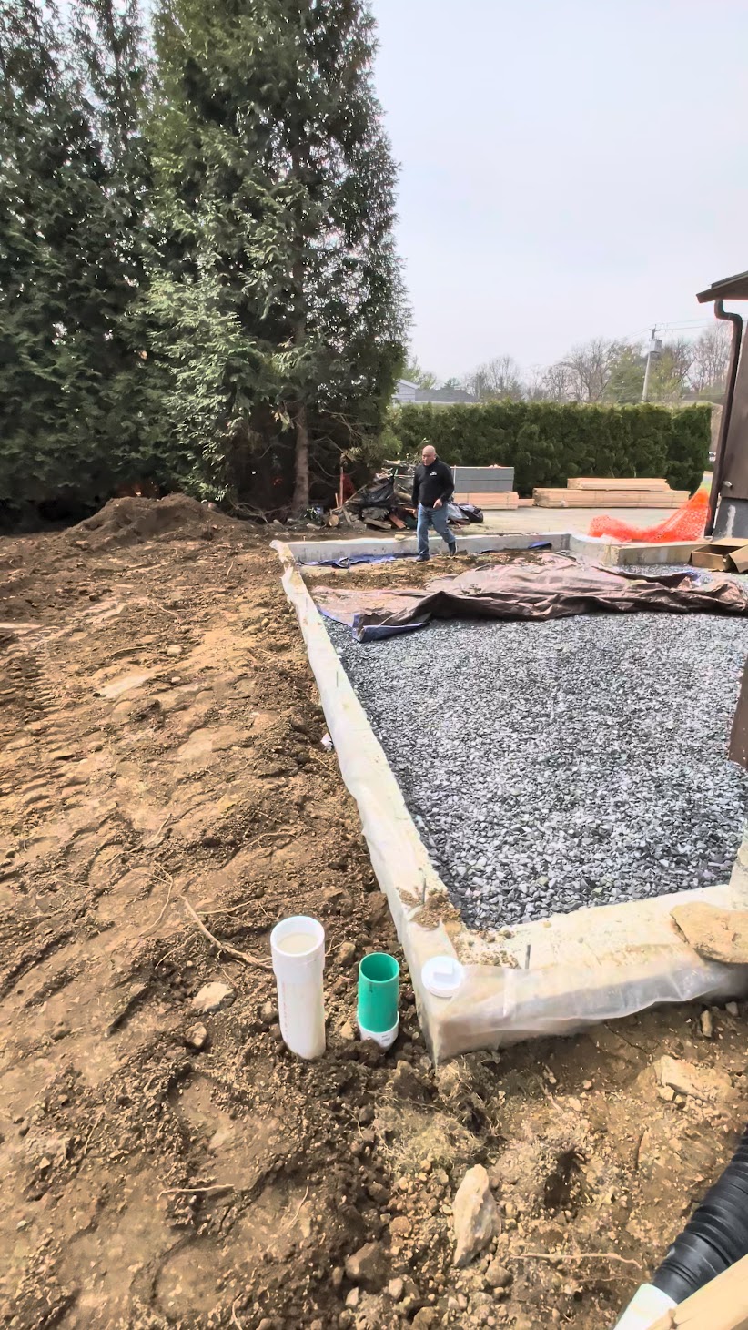 Kellets foundation preparation showing stone base, forms and service penetrations