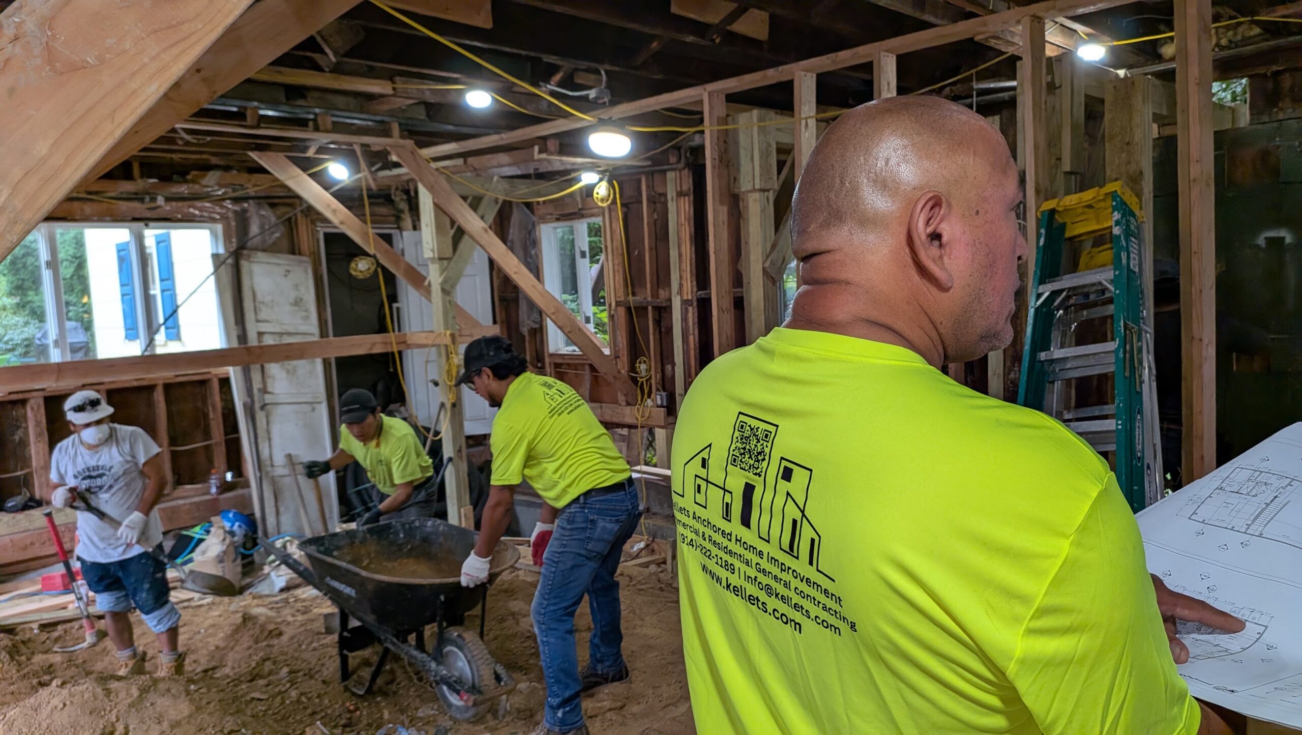 Kellets field team reviewing plans during active framing work