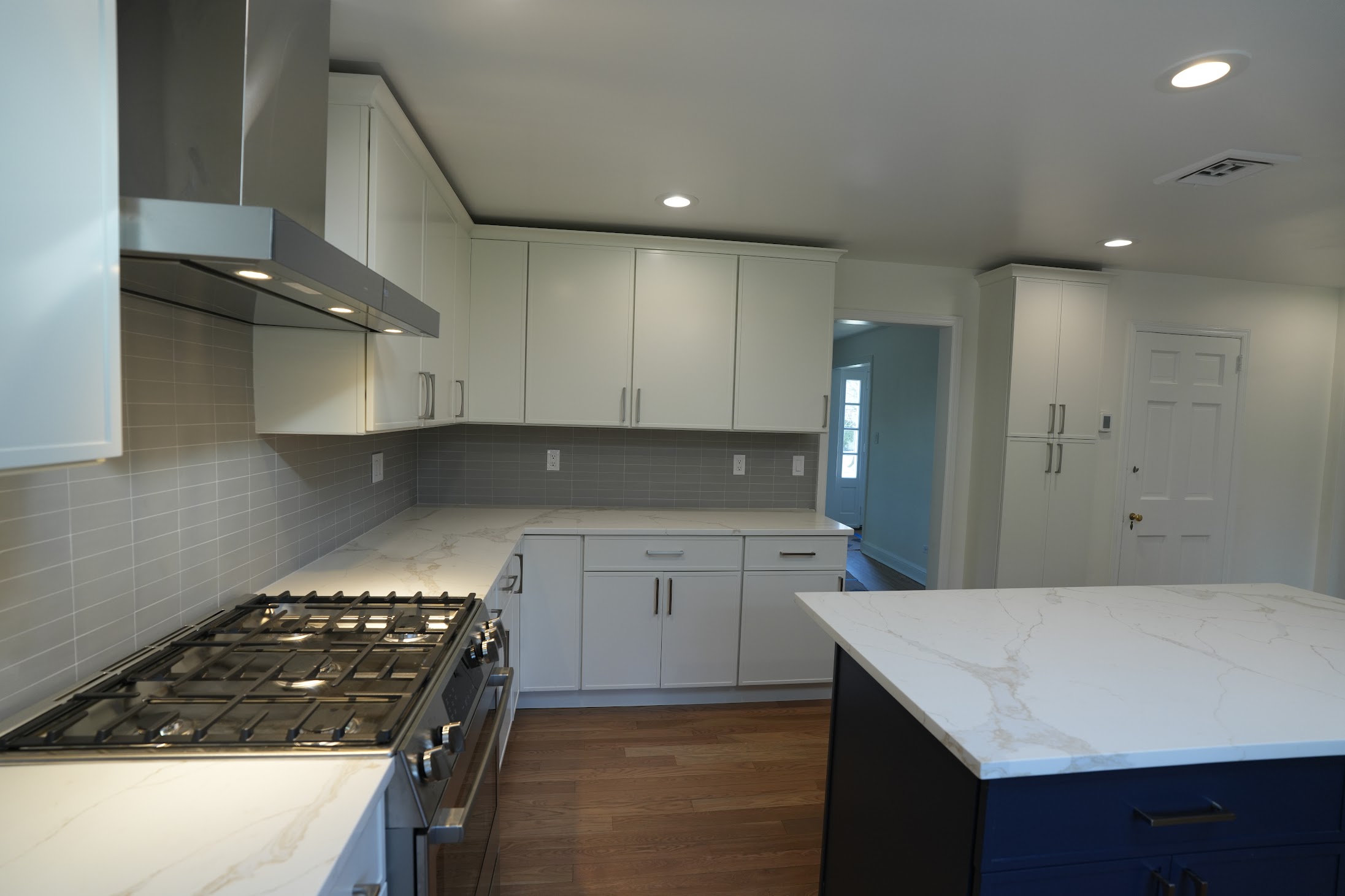 Completed Kellets kitchen with island and coordinated lighting