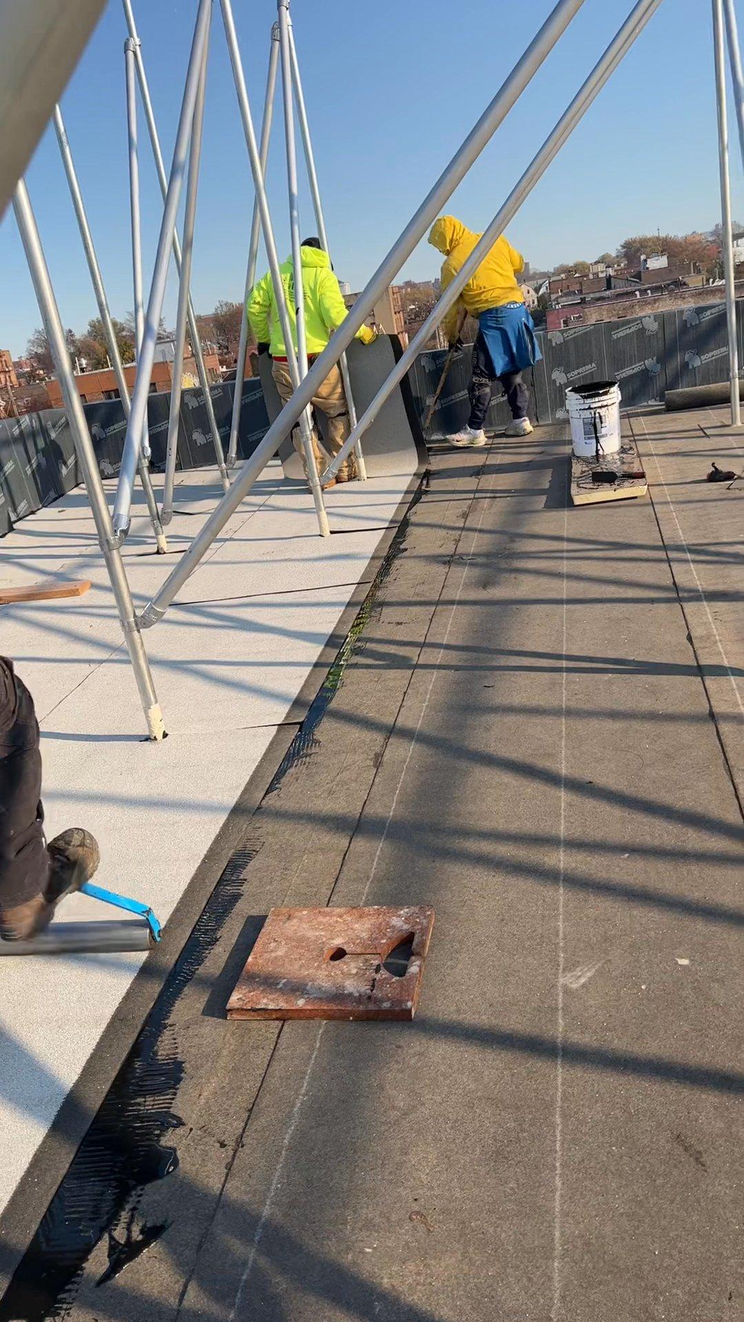 Kellets roofing crew installing the SOPREMA membrane field on a Bronx multifamily roof