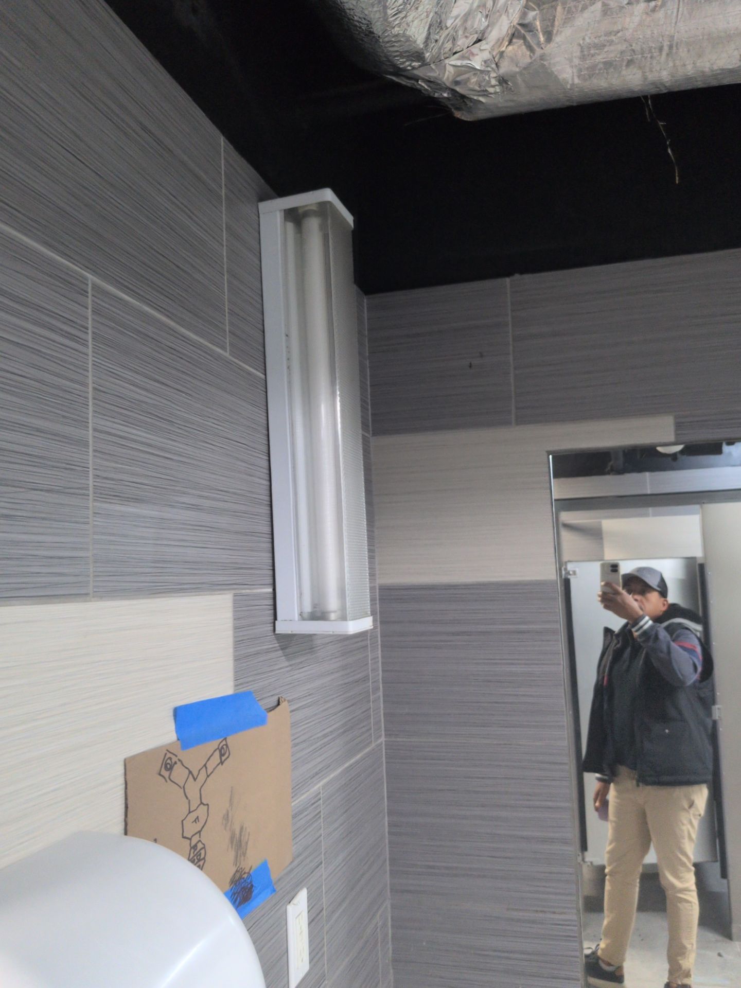 Aubrey conducting a field review inside a Manhattan commercial bathroom renovation
