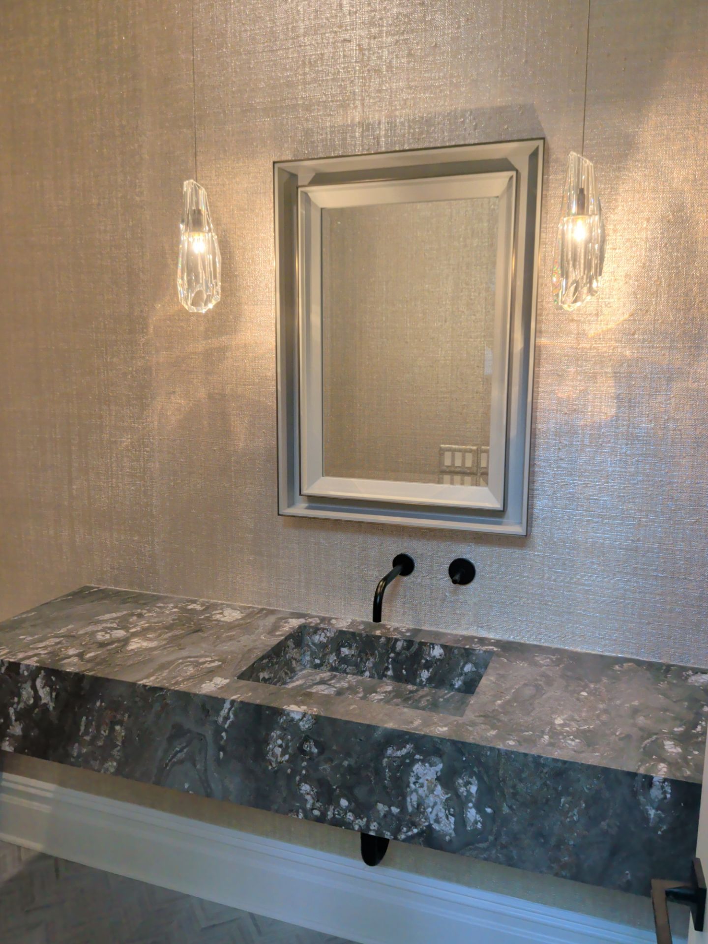 Completed Scarsdale powder room showing coordinated wallcovering, vanity, mirror and lighting